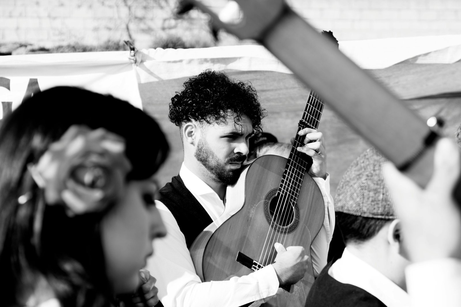 man in white dress shirt playing acoustic guitar